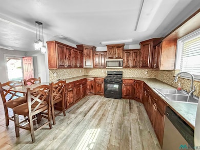 Kitchen featuring plenty of natural light, backsplash, appliances with stainless steel finishes, and light countertops