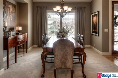 Elegant formal dining room with smooth vaulted ceiling, Plantation shutters plus drapery panels, and side board alcove.