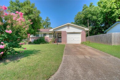 Ranch-style home featuring driveway, an attached garage, and brick siding