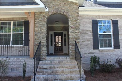 Welcome Home! This home has color coordinated Brick and Stone at the entry with Wrought Iron Rails at the Front Steps and Around the Front Porch.