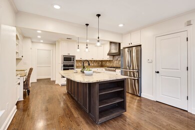 Kitchen with a sink, open shelves, white cabinetry
