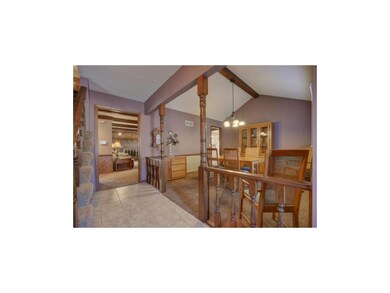 Welcoming tiled foyer opens to the formal dining a