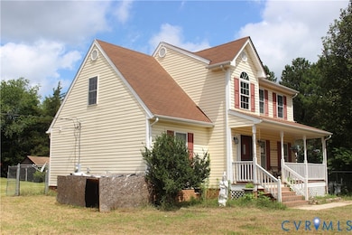 View of front facade featuring a porch and roof with shingles