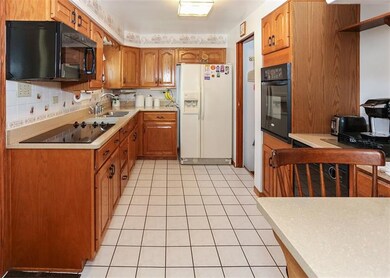 Kitchen with oak cabinets and Quartz countertops