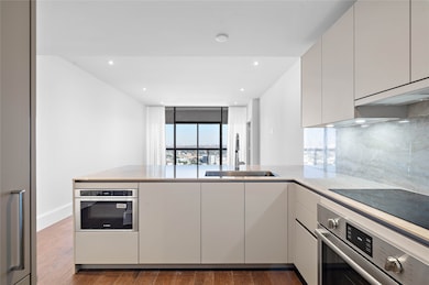 Premium Bosch appliances including convection oven, induction cooktop drawer microwave, panelized dishwasher and refrigerator-freezer.