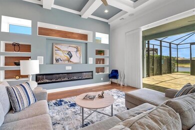 Living area featuring healthy amount of natural light, wood finished floors, coffered ceiling, beamed ceiling, and baseboards