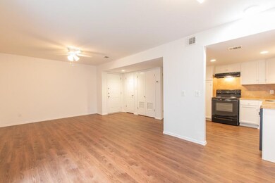 Unfurnished living room featuring a ceiling fan, 