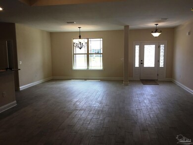 A view from living to foyer/dining is seen here.