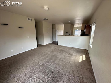 Unfurnished living room with baseboards, visible v