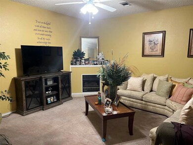 Living room featuring a textured ceiling, light co