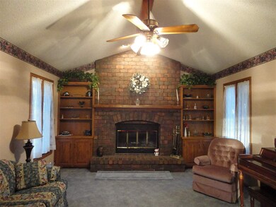 View of living room with full wall brick fireplace