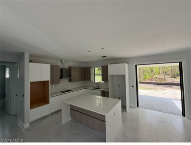 Kitchen with modern cabinets, a kitchen island, an