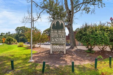 Community / neighborhood sign with a yard
