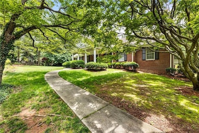 View of front of property featuring brick siding and a front yard