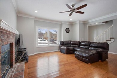Cozy brick fireplace, nice and white painted trim.