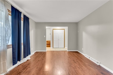 Empty room with wood finished floors and baseboards