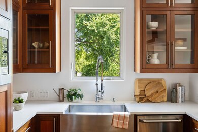 Kitchen featuring glass insert cabinets, stainles