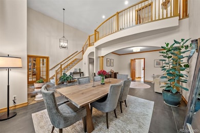 Two-story entry with open dining area, new tile floors, and warm architectural details.