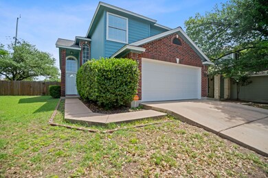 View of front of home with brick siding, a garage