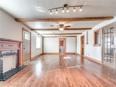 Another picture of the living room, from this angle you have see the width of the living room, and charming wood flooring.