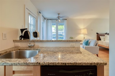 Kitchen featuring dishwashing machine, open floor
