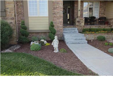 Gorgeous landscaping welcomes you into the front d