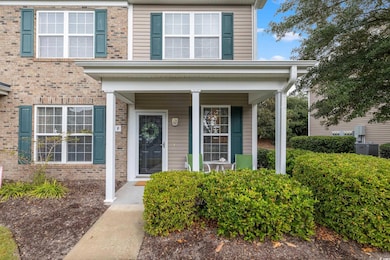 Doorway to property with a porch, cooling unit, an