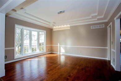 Formal dining room with hardwood, custom coffered 