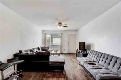 Living area featuring ceiling fan and wood finished floors