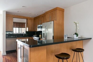 Open kitchen, with bar top around work counter. Wi