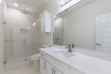 Porcelain Wall on Shower Area, Frameless Glass Door, Quarz Counter-tops, White Wood Cabinet