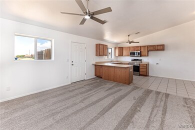 Kitchen featuring light carpet, appliances with st