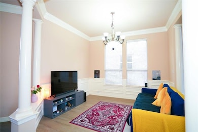 Living room featuring decorative columns, a chand