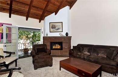 Living Room. Cozy corner fireplace. Wood beamed ce
