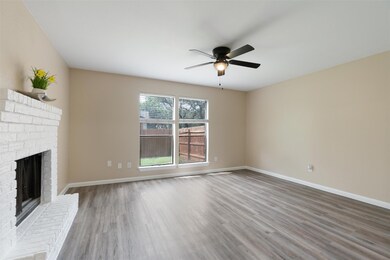 Unfurnished living room with ceiling fan, wood fi