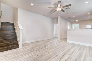 Unfurnished living room featuring a ceiling fan, 