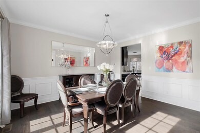 Formal dining room with wainscoting & crown moulding.