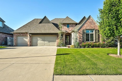 View of front facade featuring an attached garage, driveway, a front lawn, roof with shingles, and brick siding