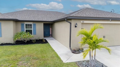 View of front facade with roof with shingles, stucco siding, an attached garage, and a front yard