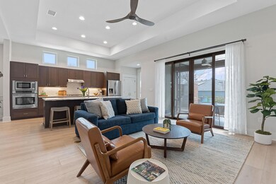 Living room with a raised ceiling, visible vents,