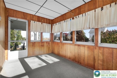 Sunporch located just off the Kitchen, offering access to the rear covered patio & yard