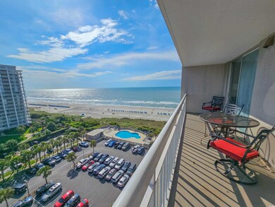 Balcony featuring a beach view and a water view