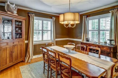 Dining room has hardwood floors, plantation shutte