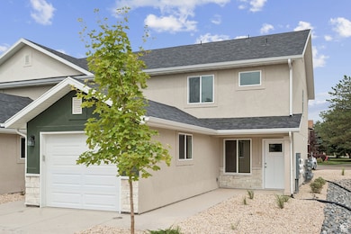 Traditional home with stucco siding, a shingled roof, stone siding, and a garage