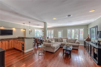 Large main living space with hard wood flooring an