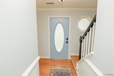 Oval glass front door in the foyer and hexagon win