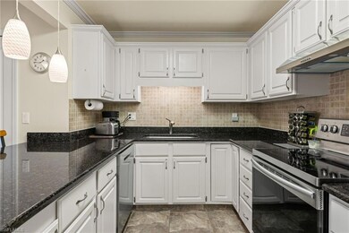 Kitchen featuring decorative light fixtures, stain