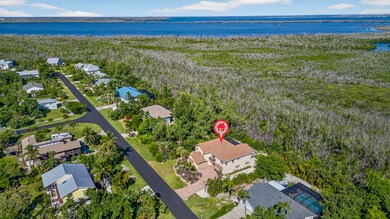 Aerial view of property's location featuring nearby suburban area and a large body of water
