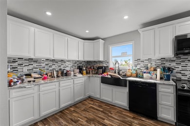Kitchen featuring white cabinetry, range with elec