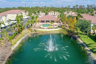 Aerial perspective of suburban area featuring a pool and a nearby body of water